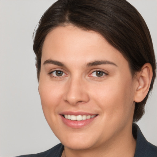 Joyful white young-adult female with medium  brown hair and brown eyes