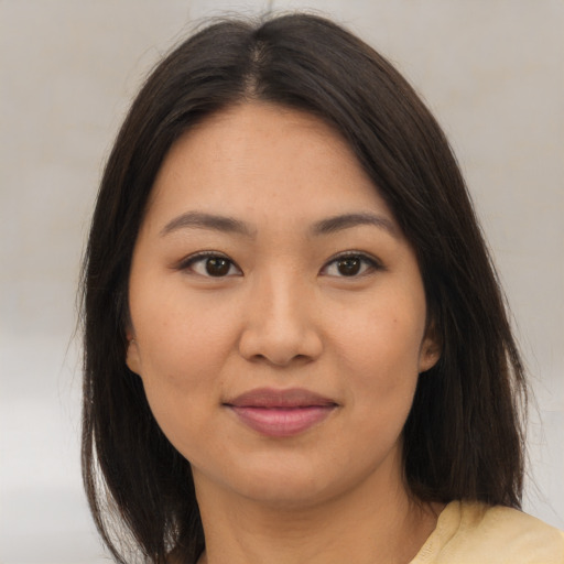 Joyful asian young-adult female with medium  brown hair and brown eyes