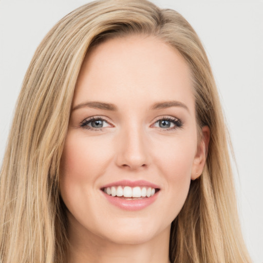 Joyful white young-adult female with long  brown hair and green eyes