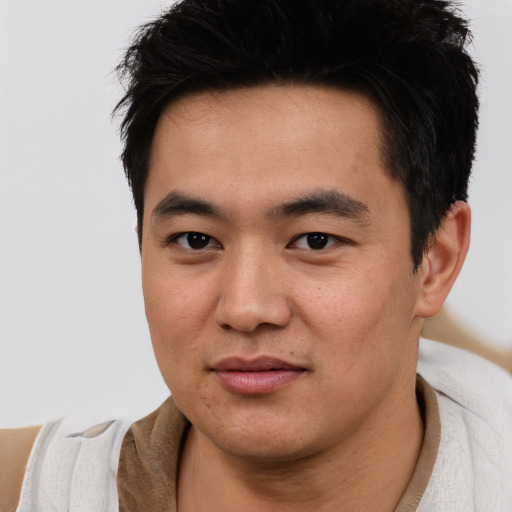 Joyful white young-adult male with short  black hair and brown eyes