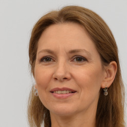 Joyful white adult female with long  brown hair and brown eyes