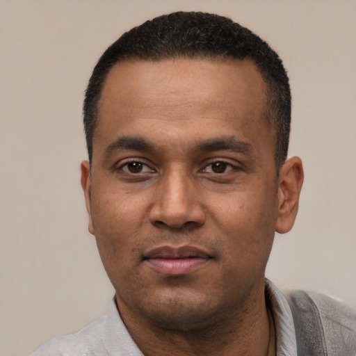 Neutral latino young-adult male with short  black hair and brown eyes