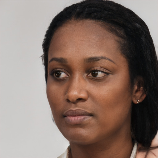 Neutral black young-adult female with medium  black hair and brown eyes