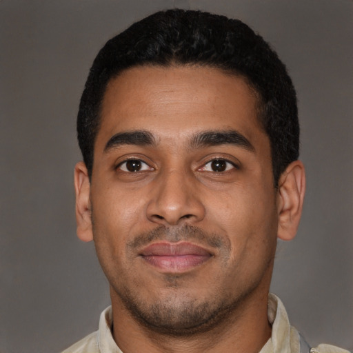 Joyful latino young-adult male with short  black hair and brown eyes