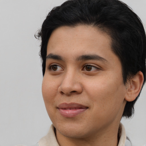 Joyful white young-adult male with medium  black hair and brown eyes