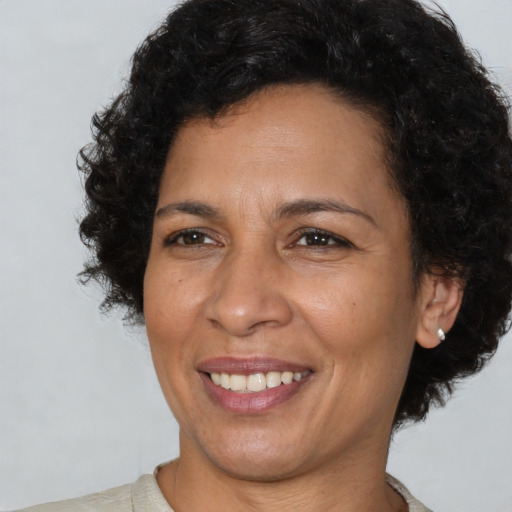 Joyful latino adult female with short  brown hair and brown eyes