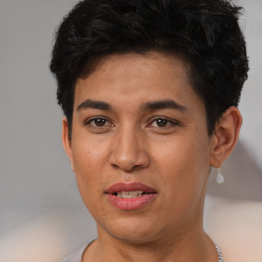 Joyful latino young-adult male with short  brown hair and brown eyes