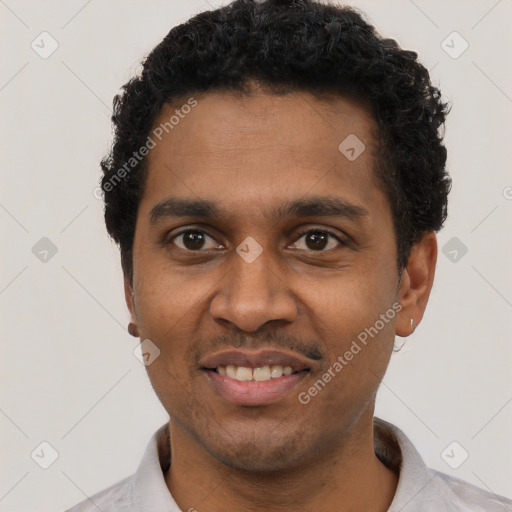 Joyful black young-adult male with short  black hair and brown eyes