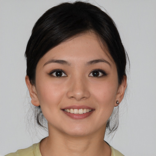 Joyful asian young-adult female with medium  brown hair and brown eyes