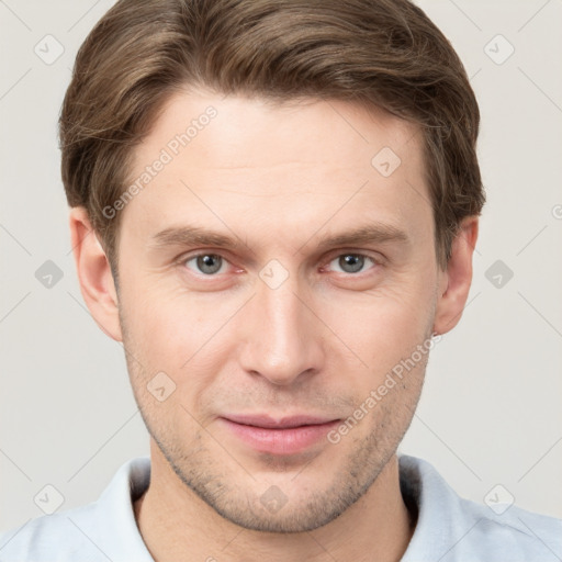 Joyful white young-adult male with short  brown hair and grey eyes