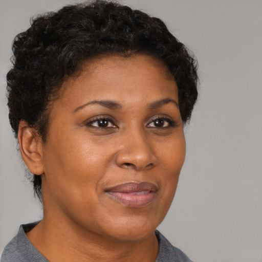 Joyful black adult female with short  brown hair and brown eyes