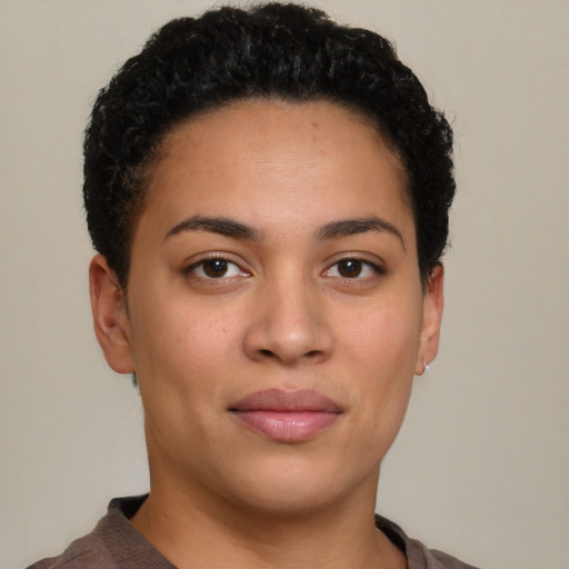 Joyful latino young-adult female with short  brown hair and brown eyes