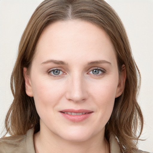 Joyful white young-adult female with long  brown hair and grey eyes