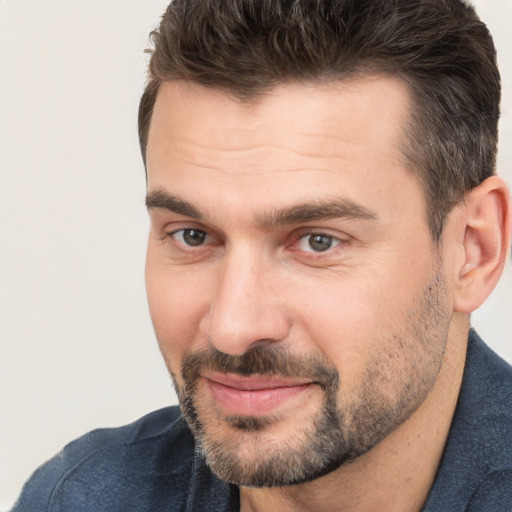 Joyful white adult male with short  brown hair and brown eyes