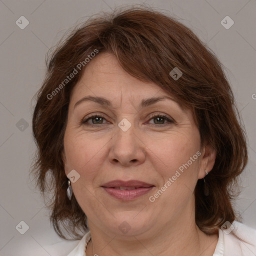 Joyful white adult female with medium  brown hair and brown eyes