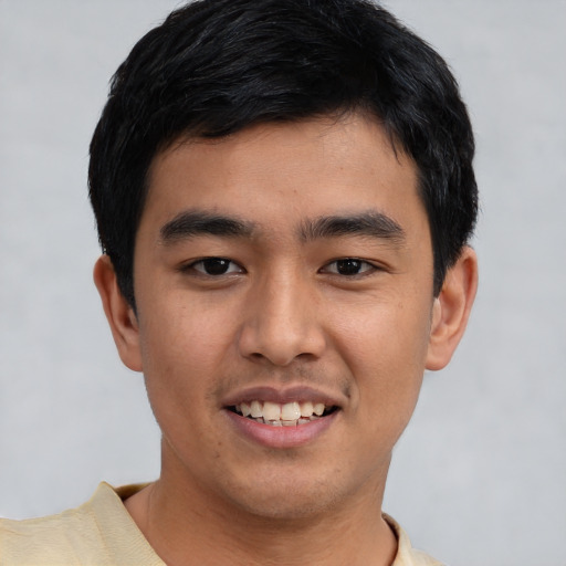 Joyful white young-adult male with short  black hair and brown eyes
