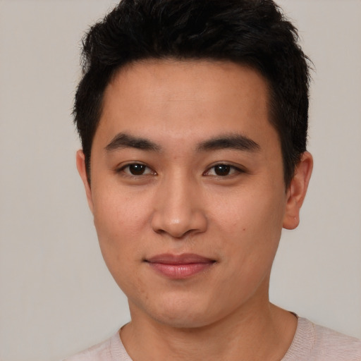 Joyful asian young-adult male with short  black hair and brown eyes