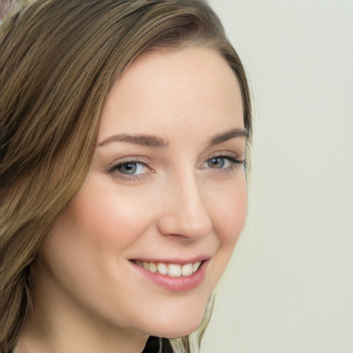 Joyful white young-adult female with long  brown hair and green eyes