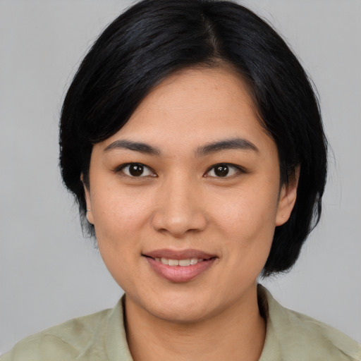 Joyful asian young-adult female with medium  black hair and brown eyes