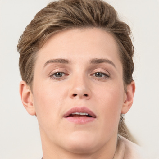 Joyful white young-adult female with short  brown hair and grey eyes