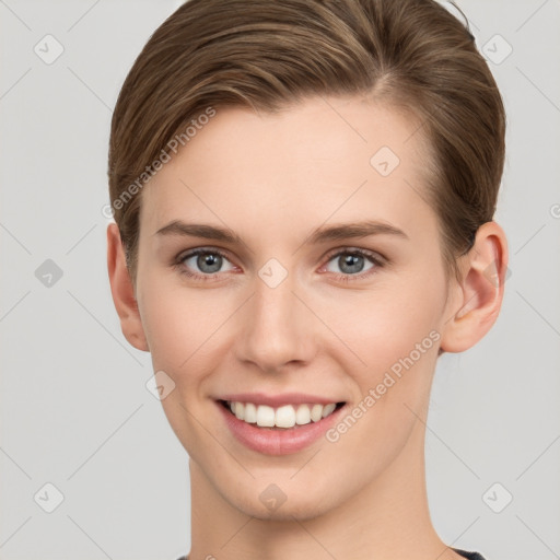 Joyful white young-adult female with short  brown hair and grey eyes