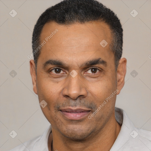 Joyful latino adult male with short  black hair and brown eyes