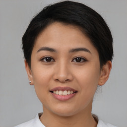 Joyful asian young-adult female with short  brown hair and brown eyes