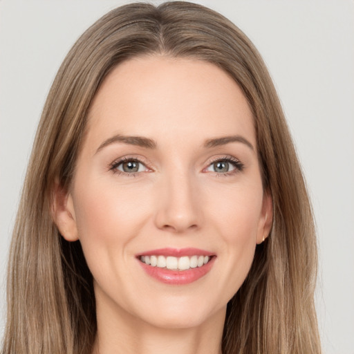 Joyful white young-adult female with long  brown hair and brown eyes