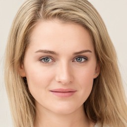 Joyful white young-adult female with long  brown hair and blue eyes