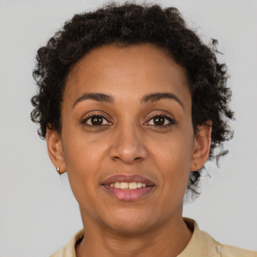 Joyful latino adult female with short  brown hair and brown eyes