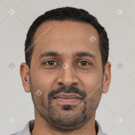 Joyful latino adult male with short  black hair and brown eyes