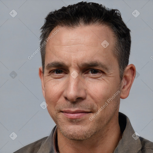 Joyful white adult male with short  black hair and brown eyes