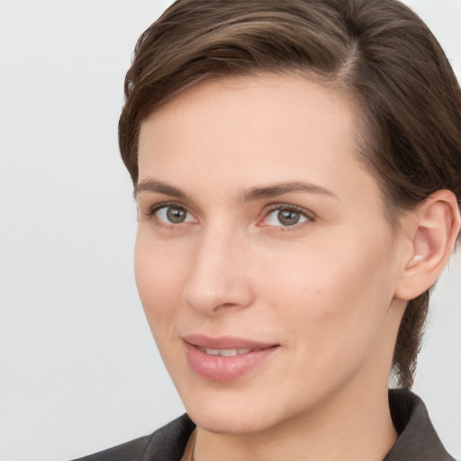 Joyful white young-adult female with medium  brown hair and grey eyes