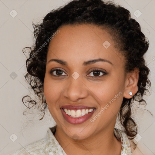 Joyful black young-adult female with medium  brown hair and brown eyes