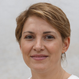 Joyful white adult female with medium  brown hair and brown eyes