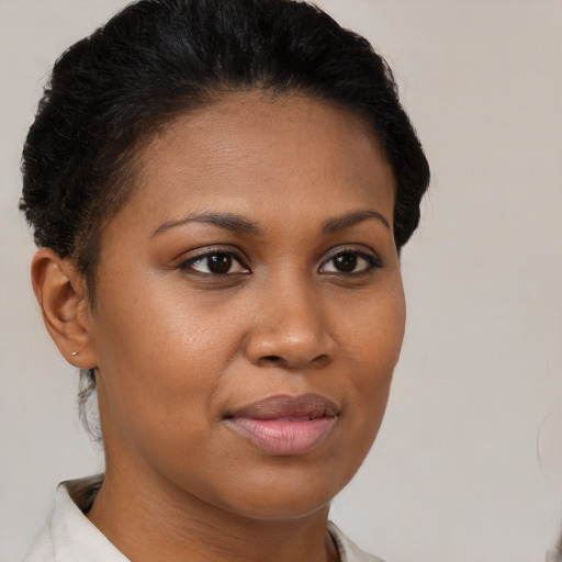 Joyful black young-adult female with short  brown hair and brown eyes