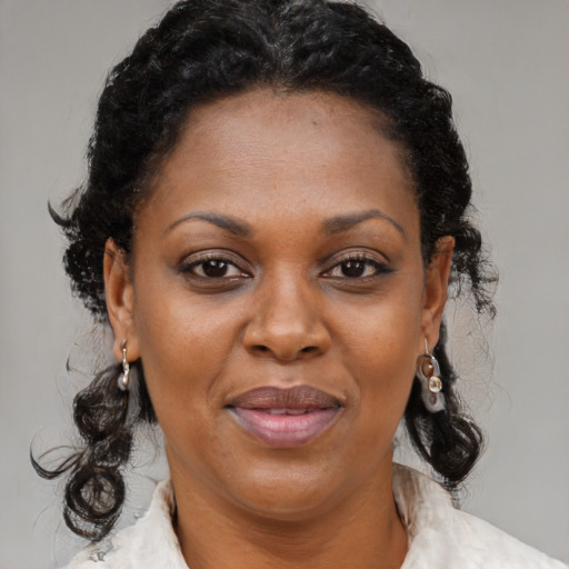Joyful black adult female with medium  brown hair and brown eyes