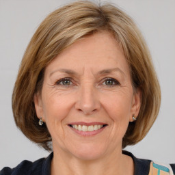 Joyful white adult female with medium  brown hair and grey eyes