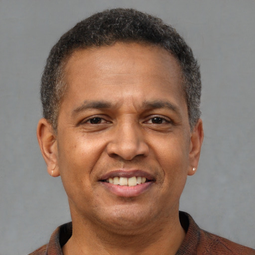 Joyful latino adult male with short  brown hair and brown eyes