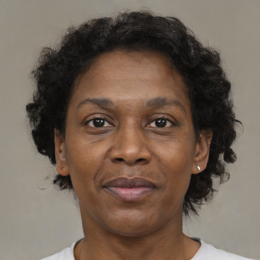 Joyful black adult female with short  brown hair and brown eyes