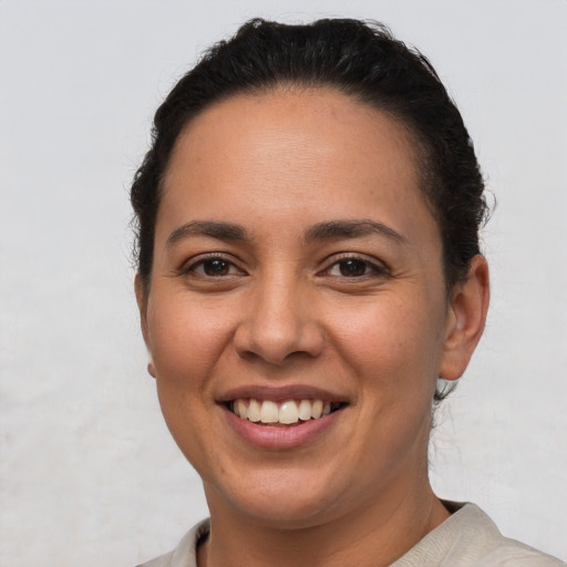 Joyful latino young-adult female with short  brown hair and brown eyes