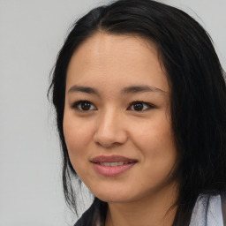 Joyful asian young-adult female with long  black hair and brown eyes