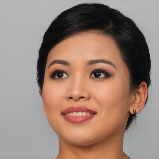 Joyful asian young-adult female with medium  black hair and brown eyes