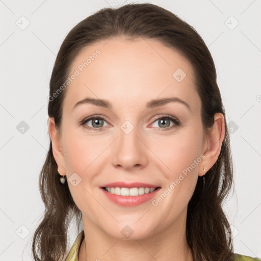 Joyful white young-adult female with long  brown hair and grey eyes