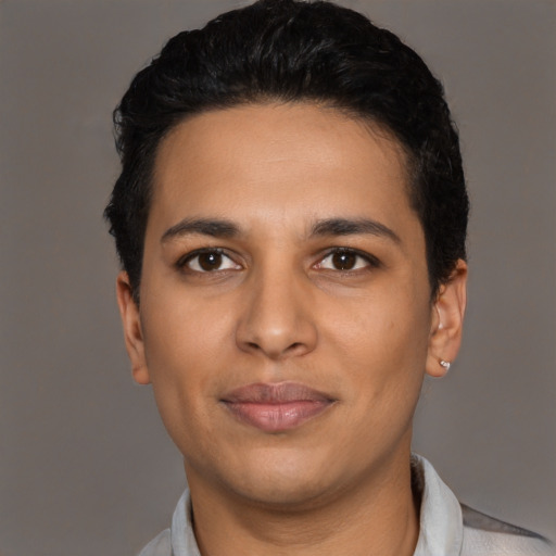 Joyful latino young-adult male with short  black hair and brown eyes