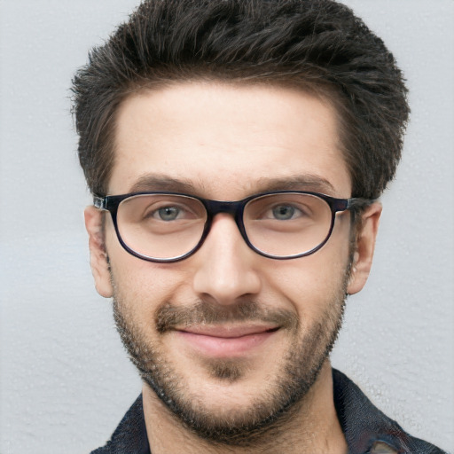 Joyful white young-adult male with short  brown hair and blue eyes