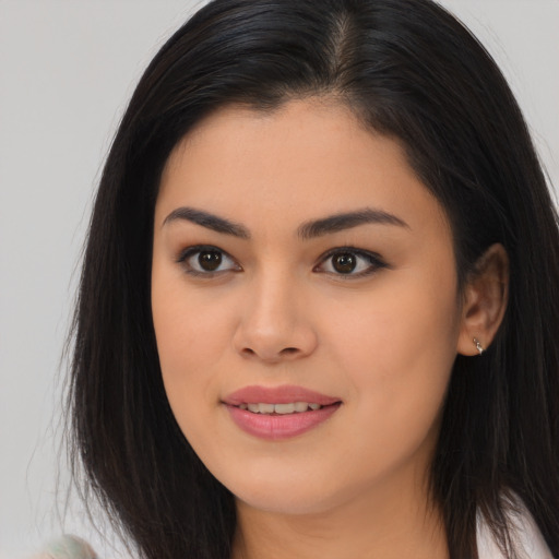 Joyful asian young-adult female with long  brown hair and brown eyes