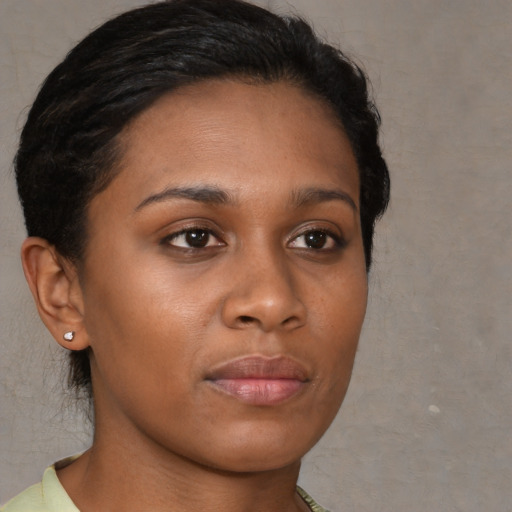 Joyful black young-adult female with short  brown hair and brown eyes