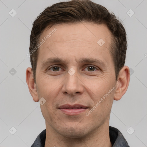 Joyful white adult male with short  brown hair and grey eyes