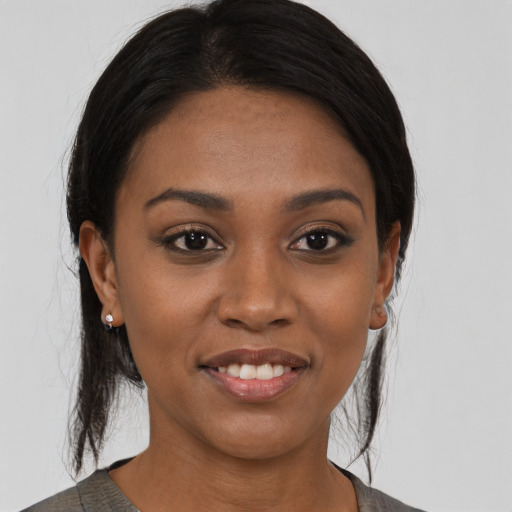 Joyful latino young-adult female with medium  black hair and brown eyes